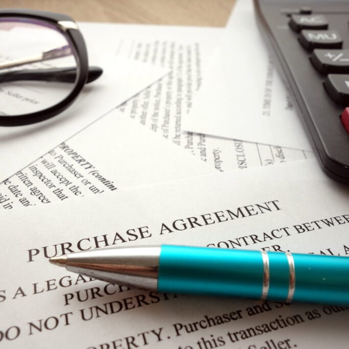 Purchase agreement document for filling and signing on desk